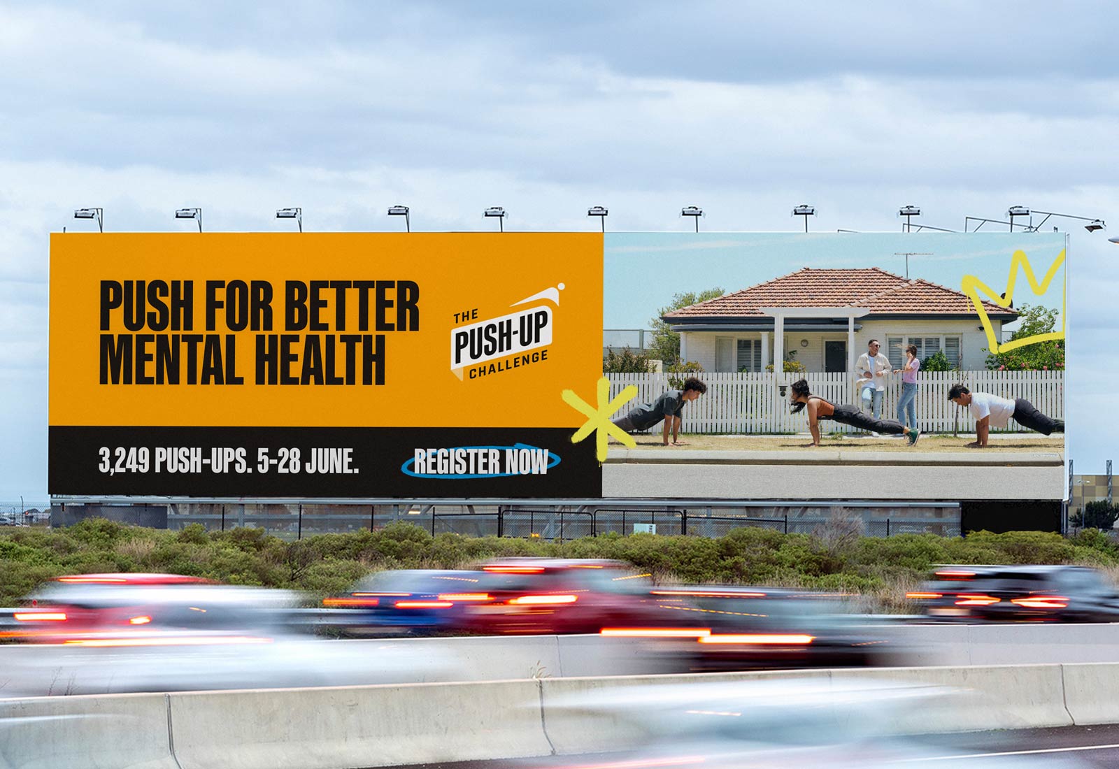 A Billboard over looks a busy freeway sporting The Push-Up Challenge brand campaign artwork